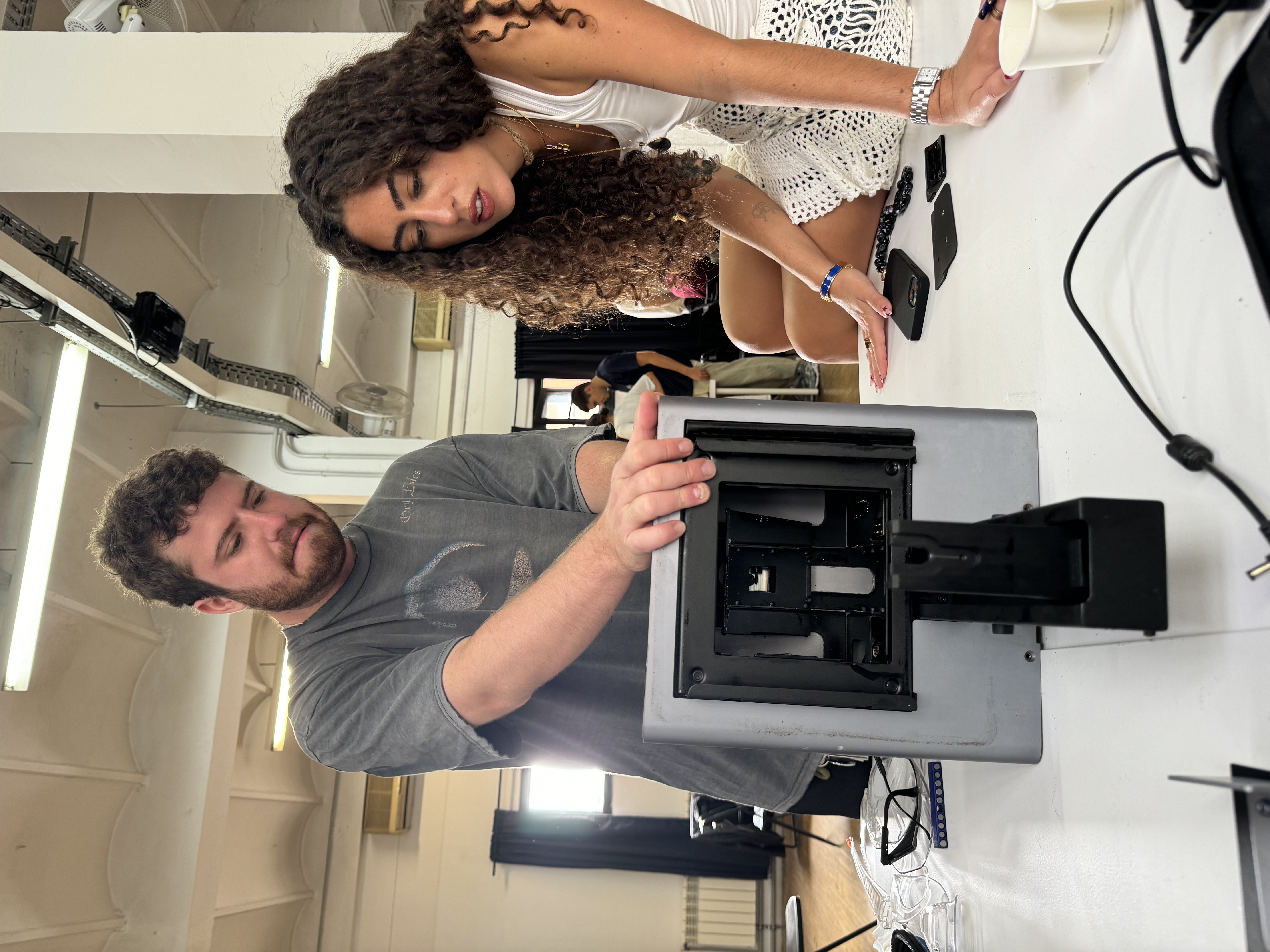 Ramon and Bélen handling parts of the printer